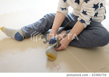 Alone. A child wearing socks 81066738
