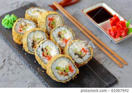 Japanese sushi tempura roll served on black stone plate Japanese sushi tempura roll served on black stone plate 81067942