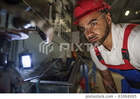 Portrait of african american male handyman working in an industrial factory Portrait of african american male handyman working in an industrial factory 81068085