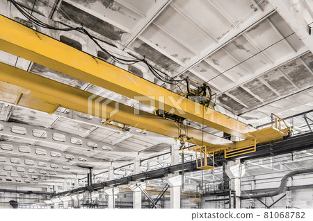Overhead construction equipment crane in an industrial plant, background production workshop 81068782