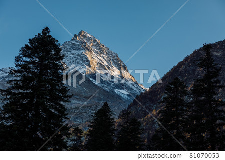 Rocky highest mountains with evening light and silhouette of mountain Rocky highest mountains with evening light and silhouette of mountain 81070053