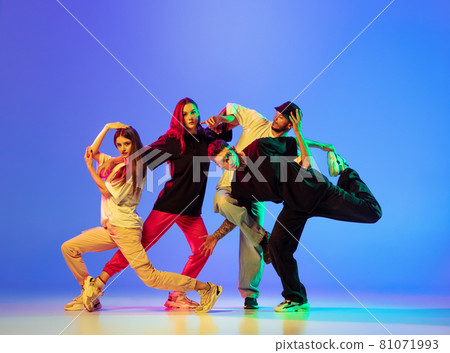 Group of young people, guys and girls in dancing contemporary dance, hip-hop, brakedance over blue background in neon light. Group of young people, guys and girls in dancing contemporary dance, hip-hop, brakedance over blue background in neon light. 81071993