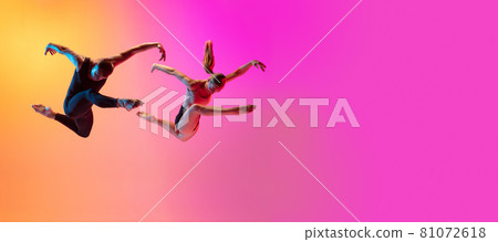 Two dancers, stylish sportive couple, male and female models dancing contemporary dance on colorful gradient yellow pink background in neon light. Two dancers, stylish sportive couple, male and female models dancing contemporary dance on colorful gradient yellow pink background in neon light. 81072618
