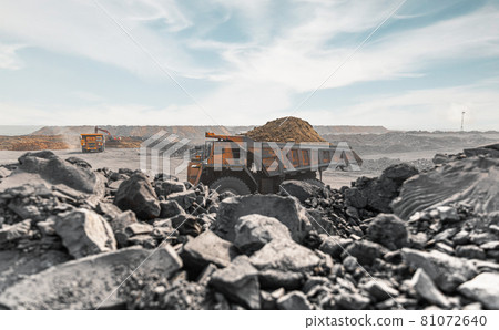 Large quarry dump truck. Big yellow mining truck at work site. Loading coal into body truck. Production useful minerals. Mining truck mining machinery to transport coal from open-pit production 81072640