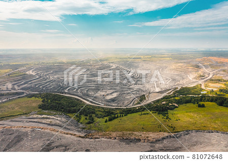 Panoramic aerial view of coal mine. Open pit mine industry, big yellow mining truck for coal quarry. Open coal mining anthracite mining. Pit on coal mining by open way. Rock loading in trucks Panoramic aerial view of coal mine. Open pit mine industry, big yellow mining truck for coal quarry. Open coal mining anthracite mining. Pit on coal mining by open way. Rock loading in trucks 81072648
