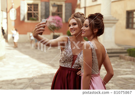 European girls take selfie on mobile phone in city European girls take selfie on mobile phone in city 81075867