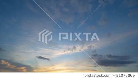 Sunset sky. Abstract nature background. Dramatic blue with orange colorful clouds in twilight time. 81075869