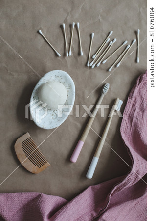 Eco spa friendly products. Handmade natural soap, wooden toothbrushes, cotton swabs and hairbrush on craft paper background top view with copyspace Eco spa friendly products. Handmade natural soap, wooden toothbrushes, cotton swabs and hairbrush on craft paper background top view with copyspace 81076084