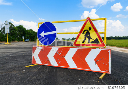 Road works sign on the road. Attention road repair. 81076805
