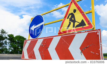 Road works sign on the road. Attention road repair. 81076806