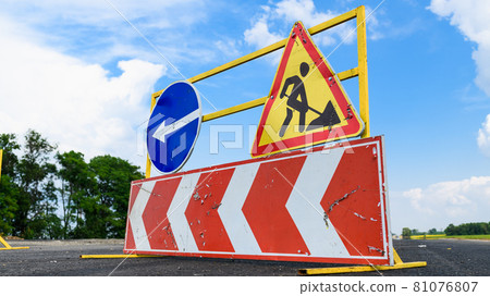 Road works sign on the road. Attention road repair. 81076807