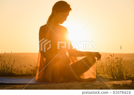 Silhouette of woman sit at yoga mat Silhouette of woman sit at yoga mat 81076828