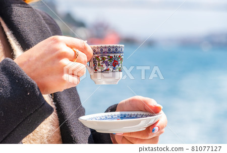 hand with turkish coffee cup and flag. Travel concept 81077127