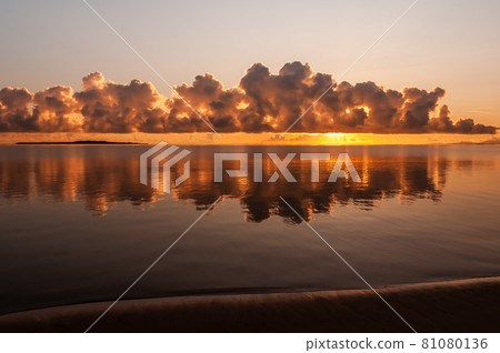 Gorgeous sunrise with incredible clouds formation  reflected in the ocean like a mirror. Iriomote Island. 81080136