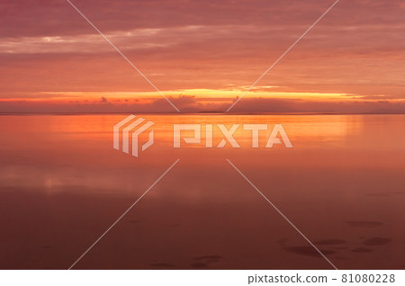 Radiant sunrise by the seashore in pink color reflecting throughout the scene. Iriomote Island. 81080228