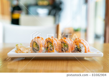 salmon roll sushi with sauce on top 81082904
