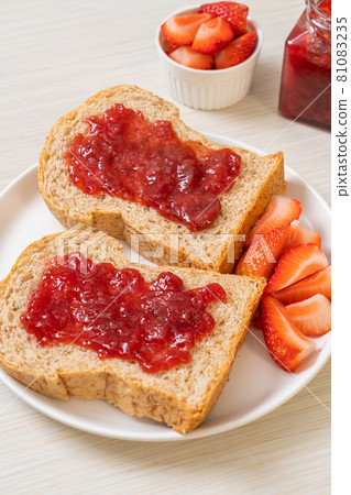 whole wheat bread with strawberry jam and fresh strawberry 81083235