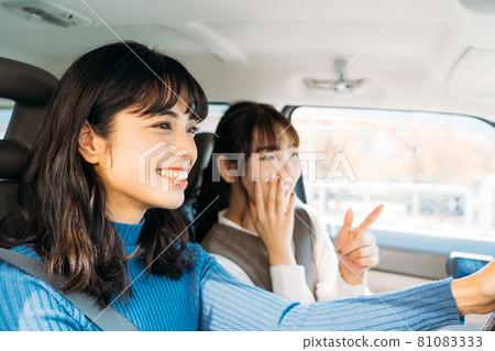 A woman enjoying a drive with friends 81083333