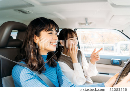 A woman enjoying a drive with friends 81083336
