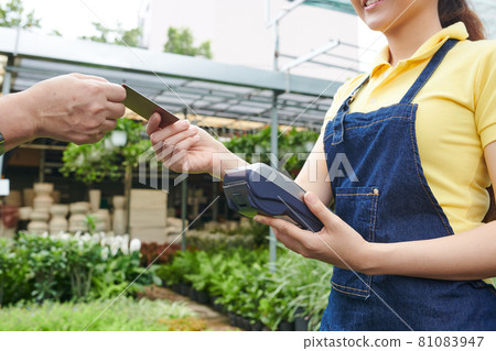 Plant Nursery Worker Accepting Payment Plant Nursery Worker Accepting Payment 81083947