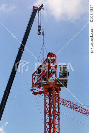 Setting up a tower crane in the construction site Setting up a tower crane in the construction site 81084334