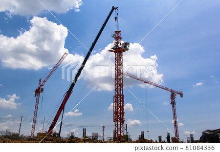 Setting up a tower crane in the construction site 81084336