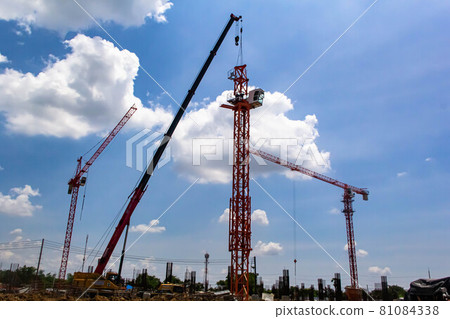 Setting up a tower crane in the construction site Setting up a tower crane in the construction site 81084338
