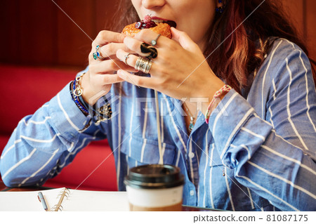 Woman Eating Ssweet Pastry 81087175