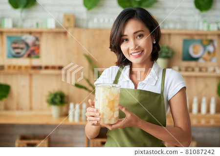 Woman Holding Jar of Cut Soap Base Woman Holding Jar of Cut Soap Base 81087242
