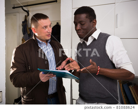 Men with documents indoor talk about the services offered 81088624