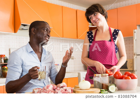 Afro man and European woman cooking Afro man and European woman cooking 81088704