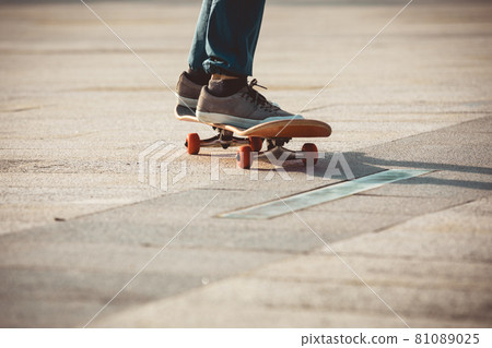 Skateboarder riding on skateboard outdoors in city 81089025