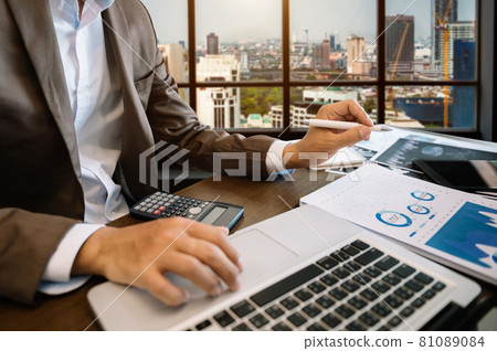 business documents on office table with smart phone and digital tablet and graph financial 81089084