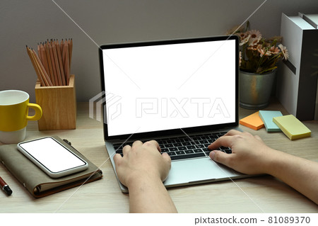 Close up view man using laptop computer on wooden table. Close up view man using laptop computer on wooden table. 81089370