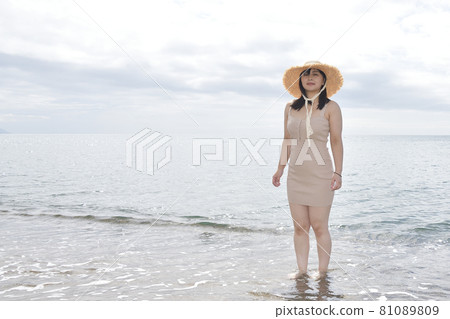 Taking a portrait of a woman in a mini one-piece in a straw hat on the coast of Esashi-cho, Hokkaido in midsummer Taking a portrait of a woman in a mini one-piece in a straw hat on the coast of Esashi-cho, Hokkaido in midsummer 81089809