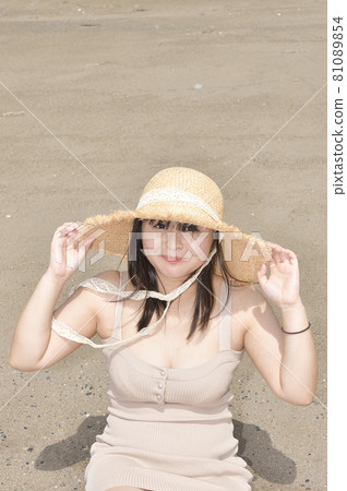 Taking a portrait of a woman in a mini one-piece in a straw hat on the coast of Esashi-cho, Hokkaido in midsummer Taking a portrait of a woman in a mini one-piece in a straw hat on the coast of Esashi-cho, Hokkaido in midsummer 81089854