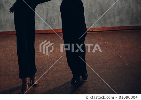 Young couple dancing ballroom dance Paso doble. Legs close up. Young couple dancing ballroom dance Paso doble. Legs close up. 81090004