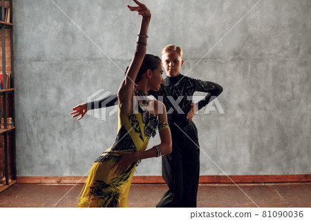 Young couple dancers dancing ballroom dance cha-cha-cha. 81090036
