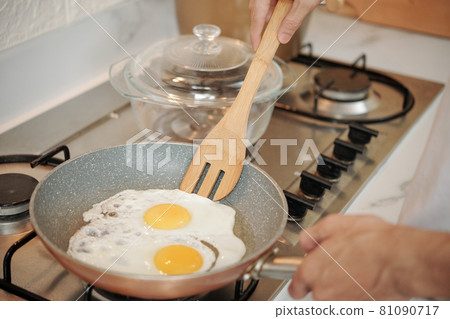 Man Frying Eggs Man Frying Eggs 81090717