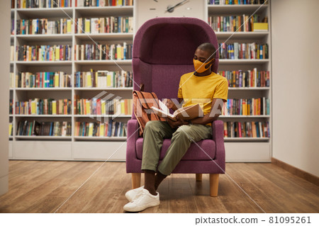 Student Reading Book in Library 81095261