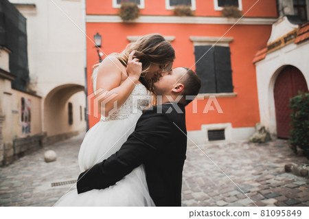 Perfect couple bride, groom posing and kissing in their wedding day 81095849
