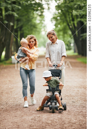 Two Mothers Enjoying Walk in Park 81096235