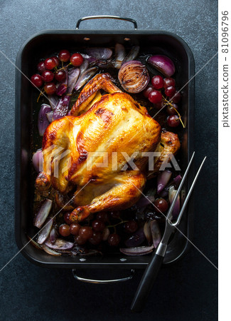 Fried chicken or turkey in a dark baking tray, top-down view Fried chicken or turkey in a dark baking tray, top-down view 81096796