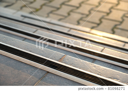 Closeup of ceramic tiles covering porch stairs with rubber anti slippery stripes on it. 81098271