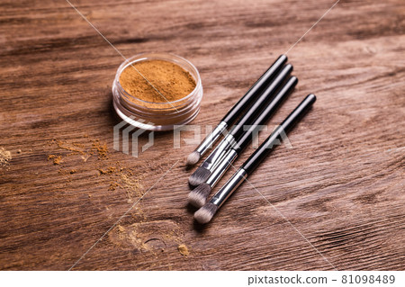 Loose compact mineral powder for face and a brushes for powder and visage on wooden background. Eco friendly and organic cosmetics. 81098489