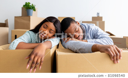 African american family sleeping on unpacked carton boxes, exhausted after moving to new house 81098540