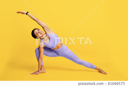 Wellness concept. Fit black woman standing in yoga pose on yellow studio background, full length portrait, free space Wellness concept. Fit black woman standing in yoga pose on yellow studio background, full length portrait, free space 81098575