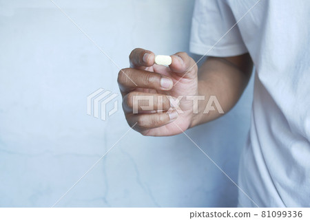 man hand holding pills with copy space man hand holding pills with copy space 81099336