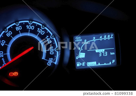 Automobile dashboard in neon light at night. Neon light in blue of car milage and speed panel during parking and many of safety icon and car status signal appearance 81099338
