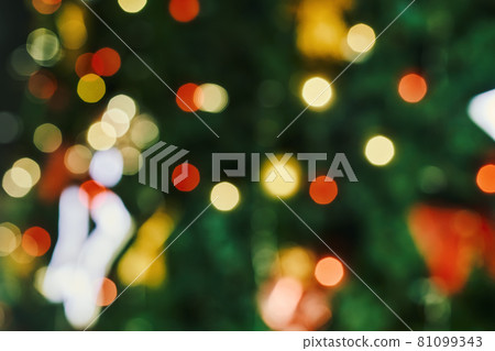 Blurred image of festive Christmas tree with decorations. Defocused christmas background. Merry Christmas background. Closeup shot of Christmas tree with Xmas decorations Blurred image of festive Christmas tree with decorations. Defocused christmas background. Merry Christmas background. Closeup shot of Christmas tree with Xmas decorations 81099343